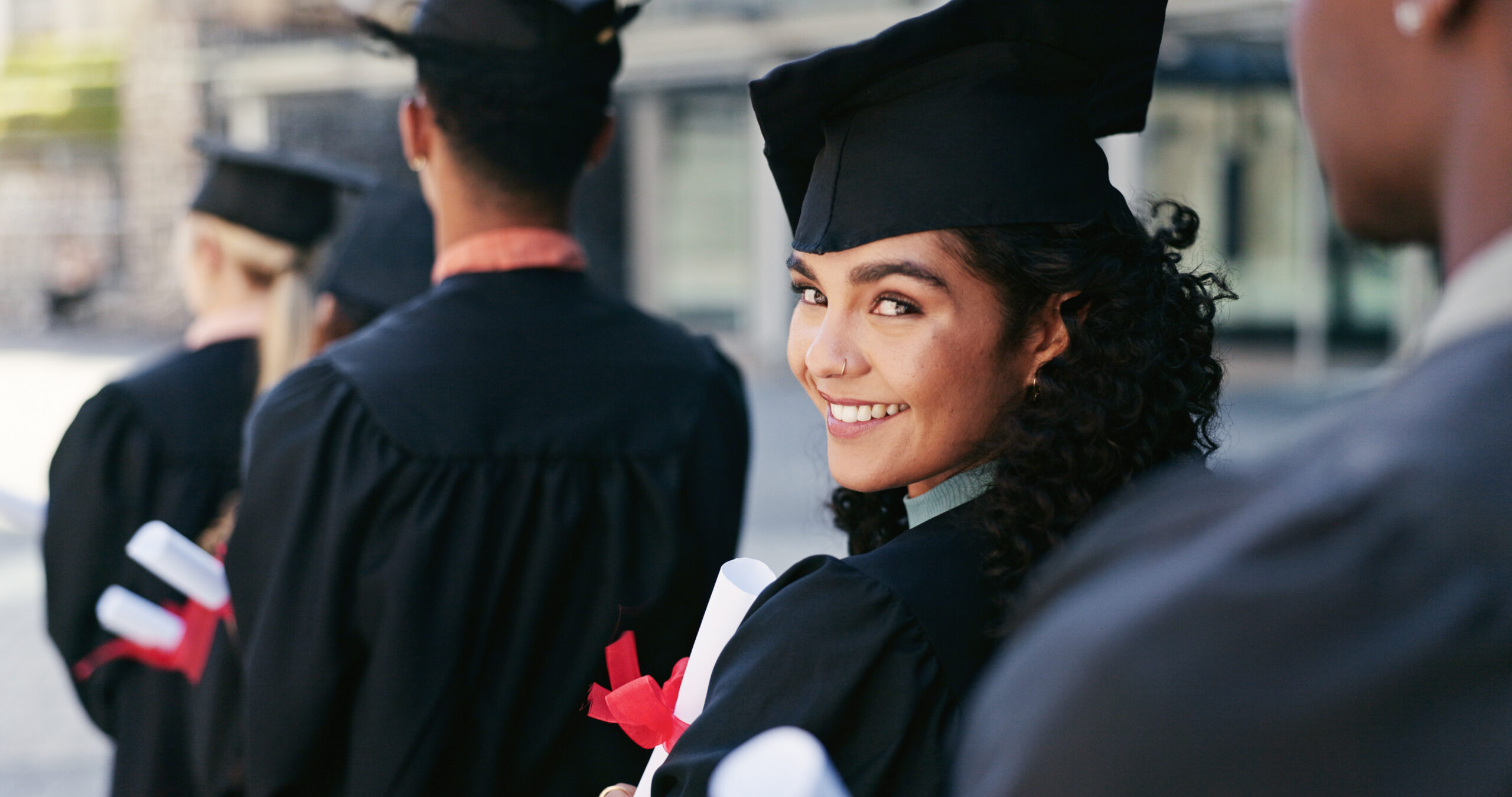 Newly graduated student celebrating success, highlighting promising job opportunities for new graduates.